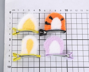 Detail of cute plush cat ear hair clips for girls showing measurements on scale board