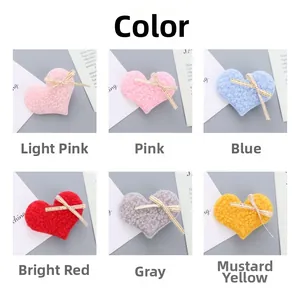 Detail of colorful plush heart hair clips with golden-edged bows in six vibrant colors