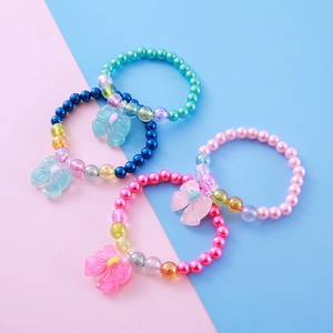 Set of four colorful beaded children's bracelets with resin bows and pearl-like charms