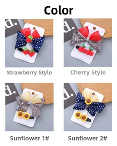 Detail view of resin bow hair clip set with strawberry and sunflower patterns on cards