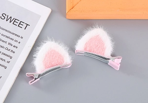 Detail of plush cat ear hair clips with soft fur texture and silver metal grip