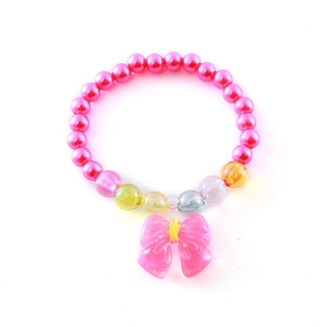 Pink beaded kids bracelet with cute bow charm and colorful imitation pearls on white background