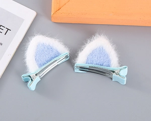 Detailed view of blue plush cat ear hair clips with non-slip fabric wrapped metal base