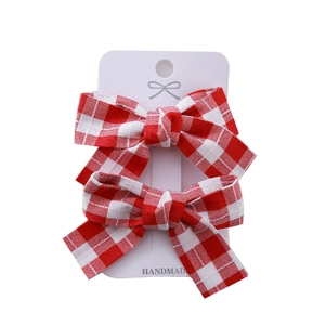 Paire de barrettes à cheveux à nœuds à carreaux rouges et blancs pour filles sur carte