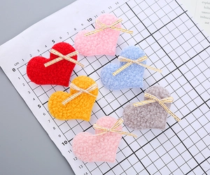 Detailed view of teddy fleece heart patches with golden-edged bows for kids hair accessories