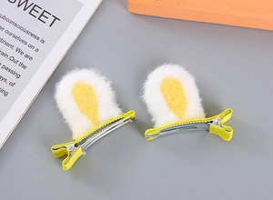Detailed view of plush rabbit ear hair clips with soft yellow and white faux fur texture