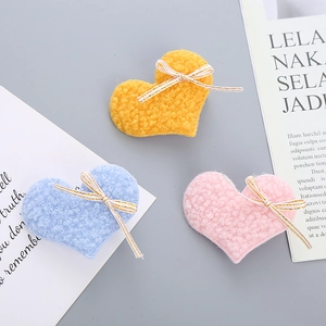 Three-color heart plush hair clips with striped bows in pink, blue, and yellow shades