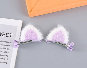 Close-up of cute plush cat ear hair clips in purple and white faux fur with metal clips