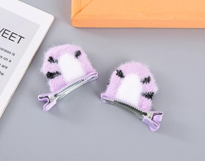 Detail shot of purple plush cat ear hair clips with animal pattern for little girls