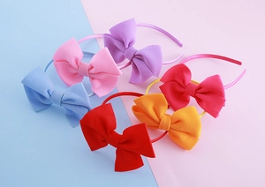 Detail showing six vibrant oversized double-layered bow headbands in assorted colors