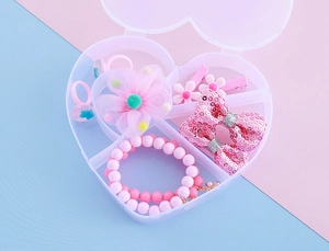 Bracelets de perles roses et bagues fleurs dans une boîte à bijoux en forme de cœur
