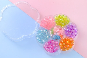 Detail of flower-shaped organizer box with colorful resin beads and bow pendant