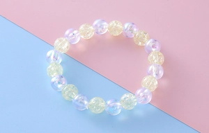 Detailed macro view of pastel crackle beads and aurora coated pearls on elastic bracelet