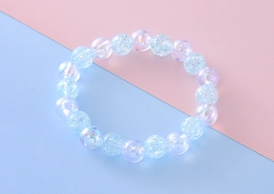 Close-up of sweet beaded bracelet with rainbow iridescent and ice crackle beads