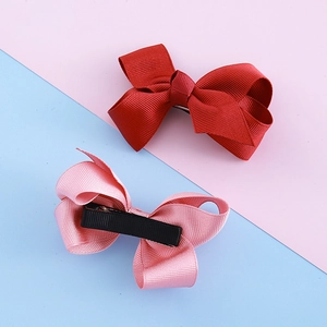 Red and pink ribbon bow hair clips set for girls with ribbed texture and alligator clips