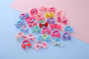 Close-up of colorful bow hair ties with strawberry and floral patterns for girls