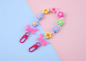 Close-up of colorful floral beaded keychain with pink bows and pastel flower charms