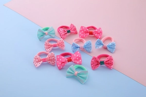 Detailed view of 10 colorful polka dot and striped bow hair ties for girls