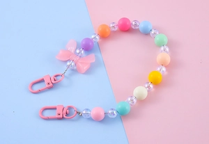 Close-up of pastel beaded keychain with pink bow and colorful frosted macaron beads