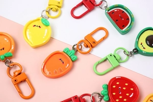 Close-up of cute resin fruit and vegetable keychains with colorful lobster clasps