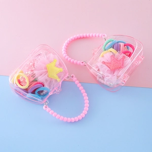 Set d'accessoires cheveux enfant avec pinces couronne et élastiques en sacs roses