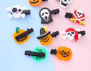 Detail of Halloween hair clips with pumpkin and ghost motifs on colorful background