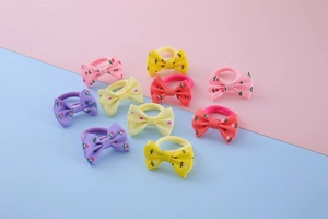 Detailed view of 10 colorful handmade bow hair ties with floral and polka dot patterns