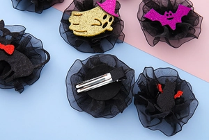 Detail showing Halloween hair clips with glitter ghosts, black cats and mesh lace