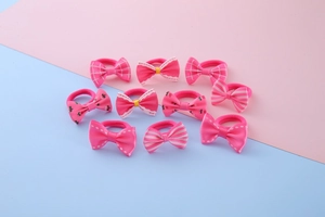 Set of 10 pink hair ties with diverse patterns like stripes, dots, and cherries