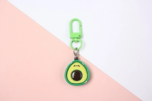 Detailed view of a cute resin avocado keychain with a green D-shaped lobster clasp