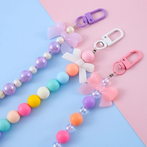 Colorful bow beaded keychain charm with macaron flower beads and pastel spring clip