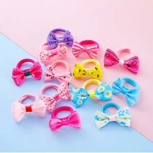 Colorful set of 12 kids hair ties with handmade bows in various patterns and vibrant colors