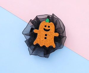 Detail of Halloween hair clip with orange glitter ghost and black mesh netting layers