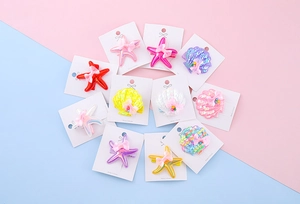 Detailed set of 11 glittery starfish and seashell hair clips for girls in candy colors