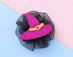 Pink sequined witch hat hair clip with black tulle detail on a blue and pink background