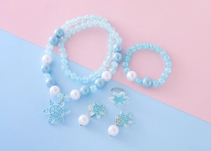 Detailed view of frozen blue snowflake pendant necklace and beaded jewelry set for girls