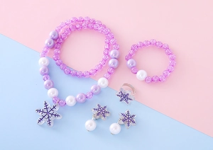 Detailed view of children's jewelry set with purple beads and snowflake pendant