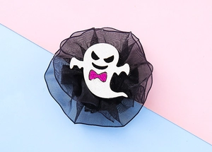 Detail of white ghost hair clip with pink glitter bow and black tulle lace design