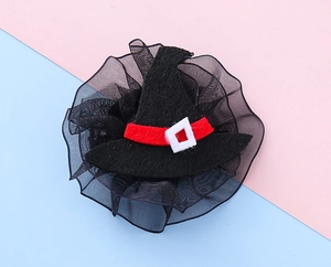 Detail of Halloween witch hat hair clip with red ribbon, white buckle and black mesh lace