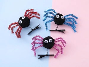 Detailed view of Halloween spider hair clips set with colorful glitter legs on spring