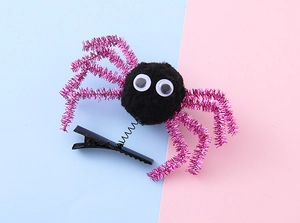 Detail of Halloween spider hair clip with pink tinsel legs and shaking spring on metal clip