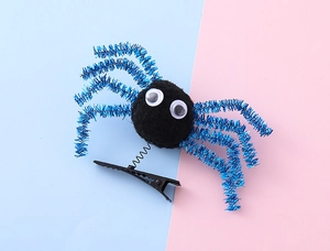 Detail of Halloween spider clip with blue glitter legs and spring-mounted plush body