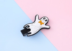 Vue détaillée d'une jolie barrette à cheveux fantôme d'Halloween avec un nœud orange