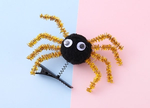 Detail of Halloween spider hair clip with fuzzy body, googly eyes and gold glitter legs