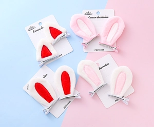 Detailed view of soft plush rabbit and cat ear hair clips with metal duckbill base