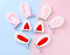 Detail of plush animal ear hair clips featuring soft cat and bunny ear designs in pastel colors