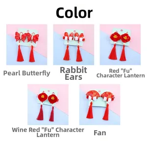 Detailed view of Chinese New Year hair clips with red tassels, lanterns and embroidery