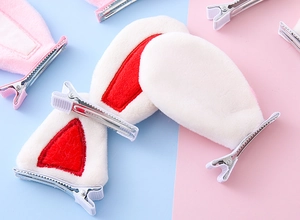 Close-up of soft plush cat and rabbit ear hair clips with metal alligator base