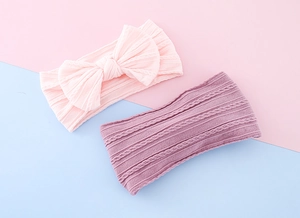 Detail of two-piece baby headbands with bow knot and elastic knitted cable pattern