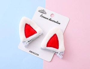 Detail of plush red and white cat ear hair clips with silver metal duckbill base
